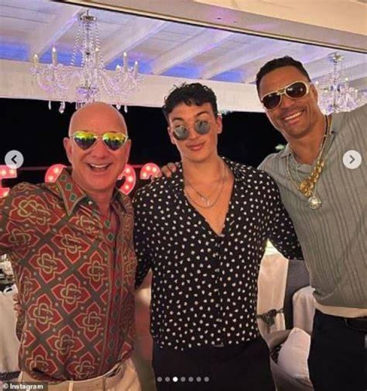 Bash: Bezos sported an orange patterned shirt along with a pair of cream chinos and sunglasses for the festivities (pictured with Lauren's son Nikko and Tony Gonzalez)